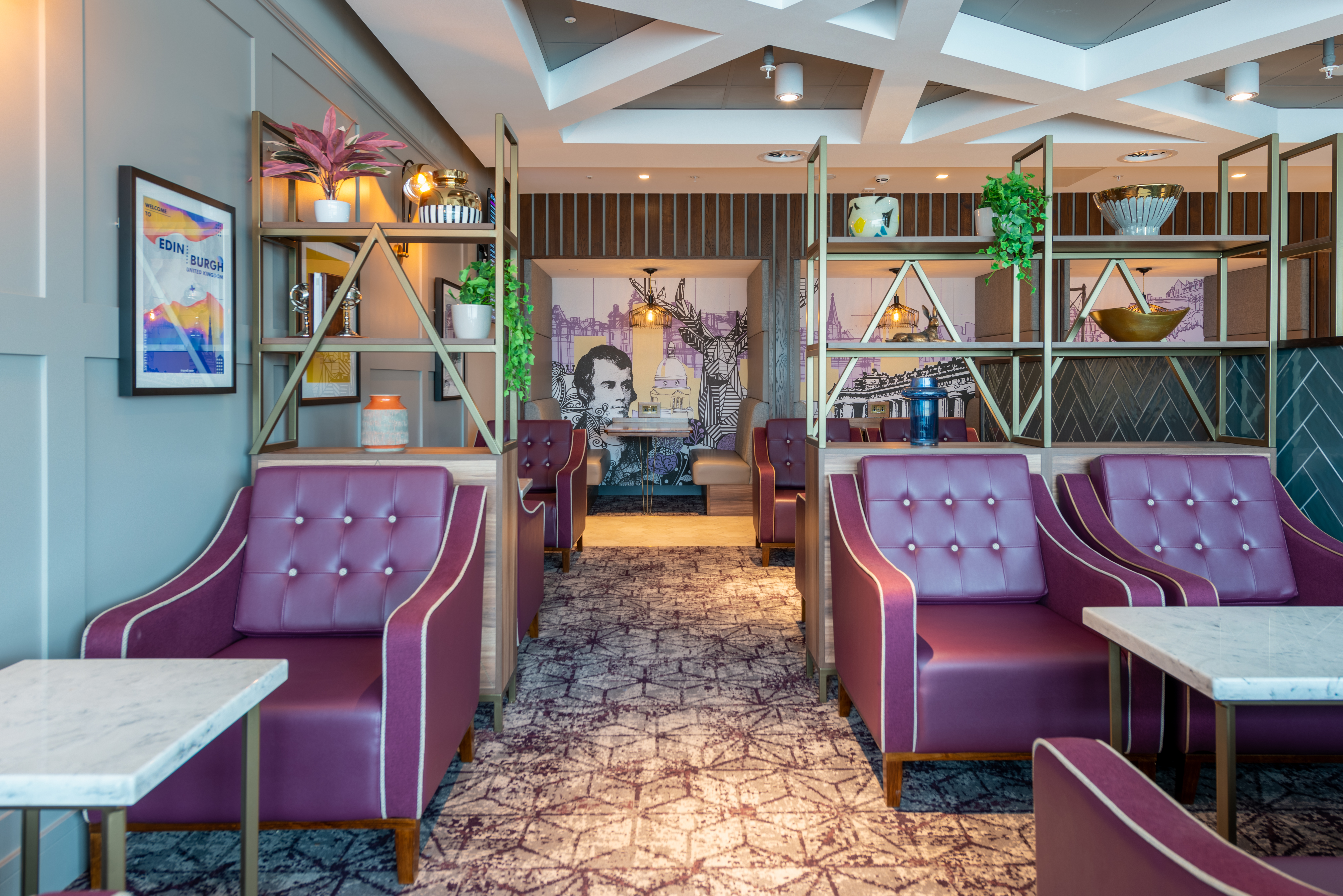 Comfortable purple armchairs at Edinburgh Gate 16 Aspire Lounge