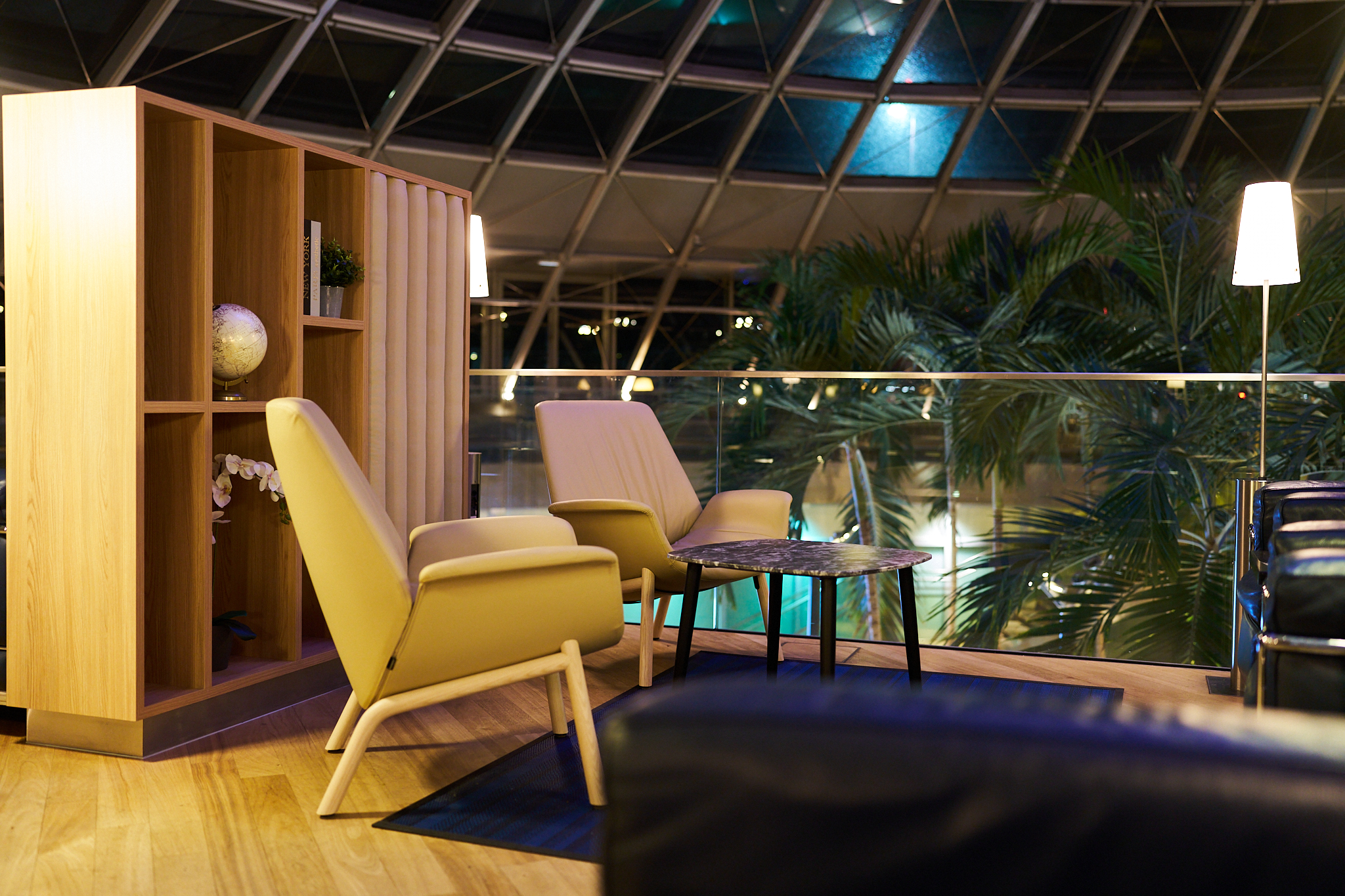 Comfortable lounge chairs around a table in the Basel Lounge