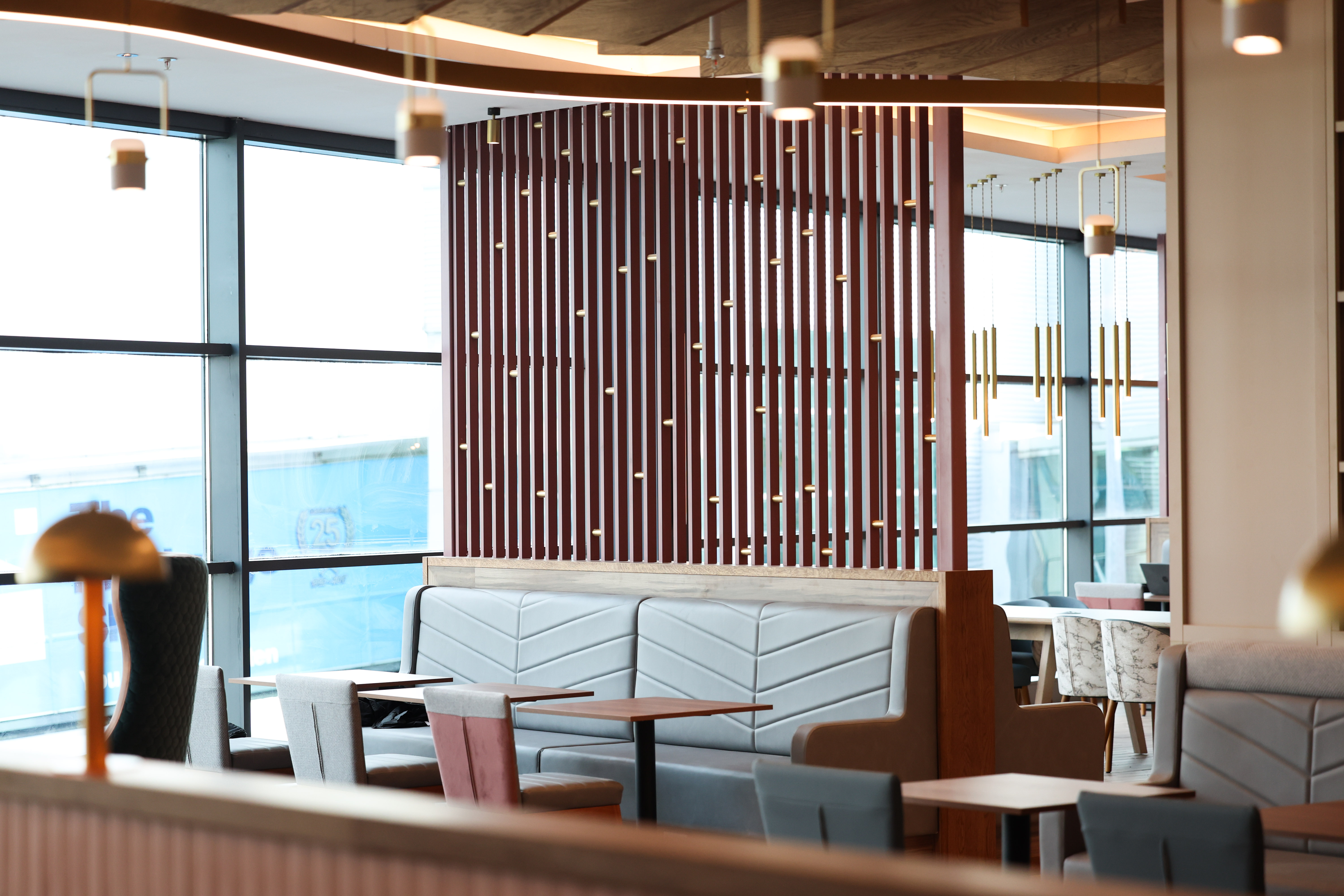 Stylish backdrop behind comfortable seating in the Belfast Aspire Lounge.