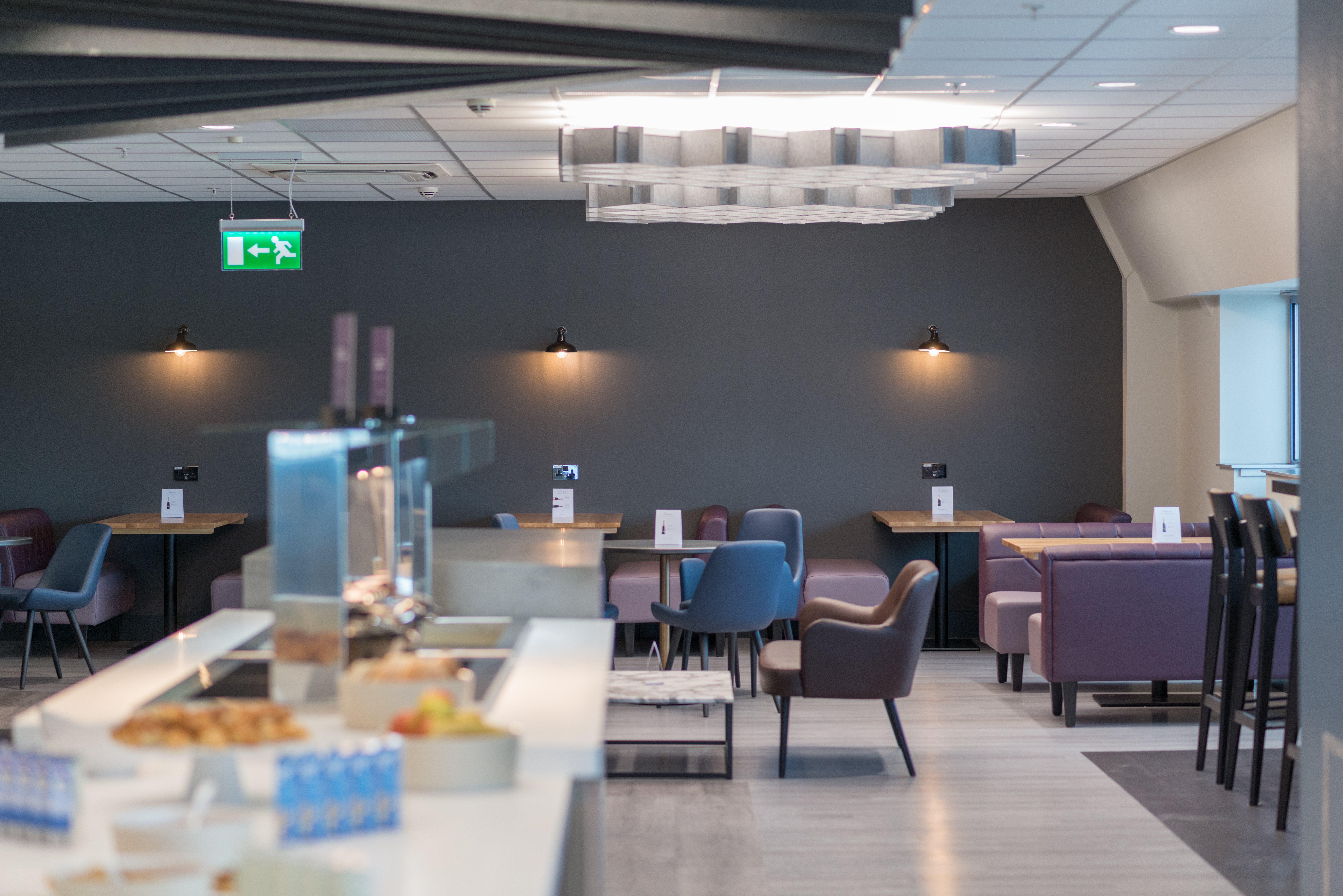 Dining table conveniently located near the buffet counter at Birmingham South Aspire Lounge.