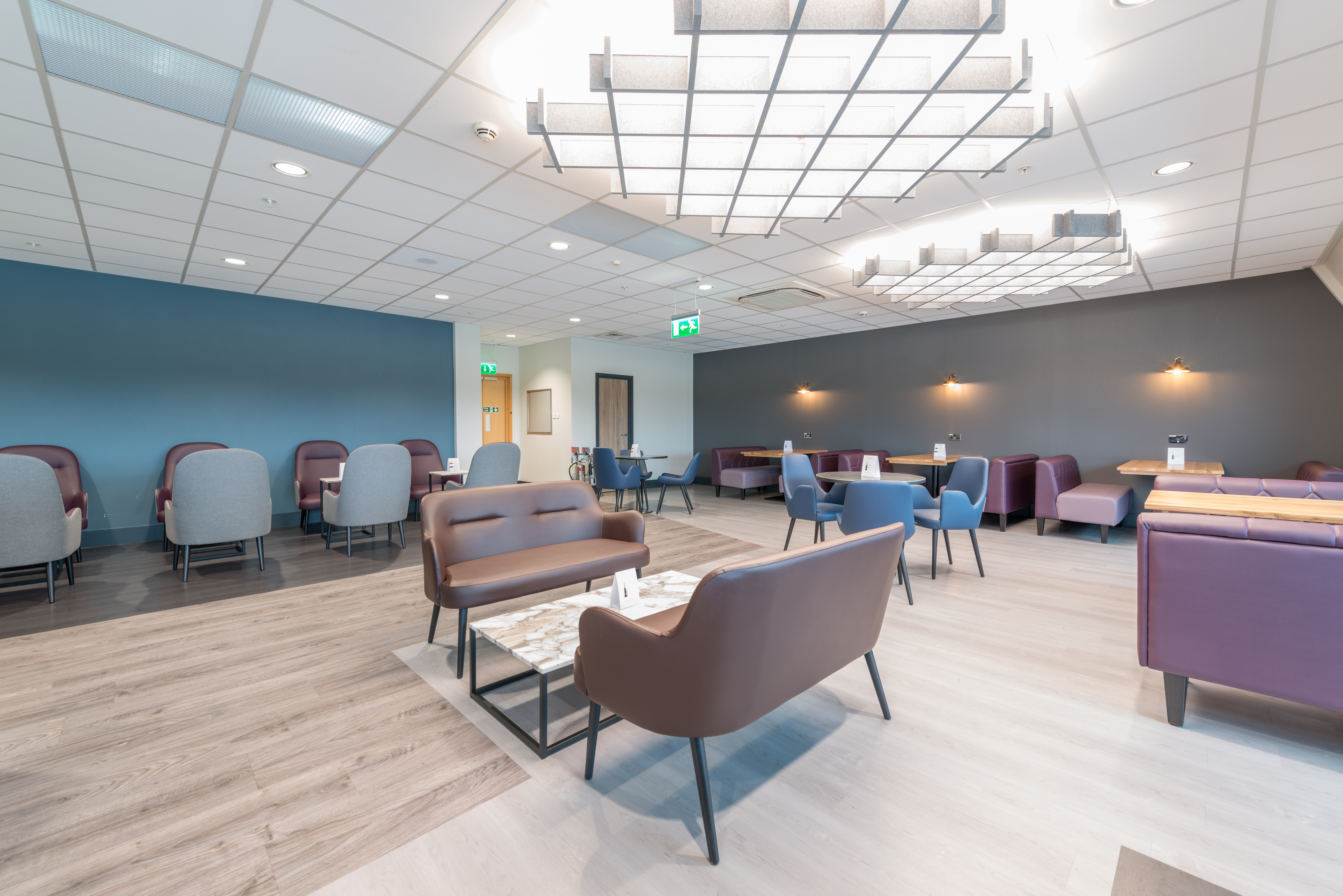 Sofa seating around a table for four travellers at Birmingham Aspire Lounge.