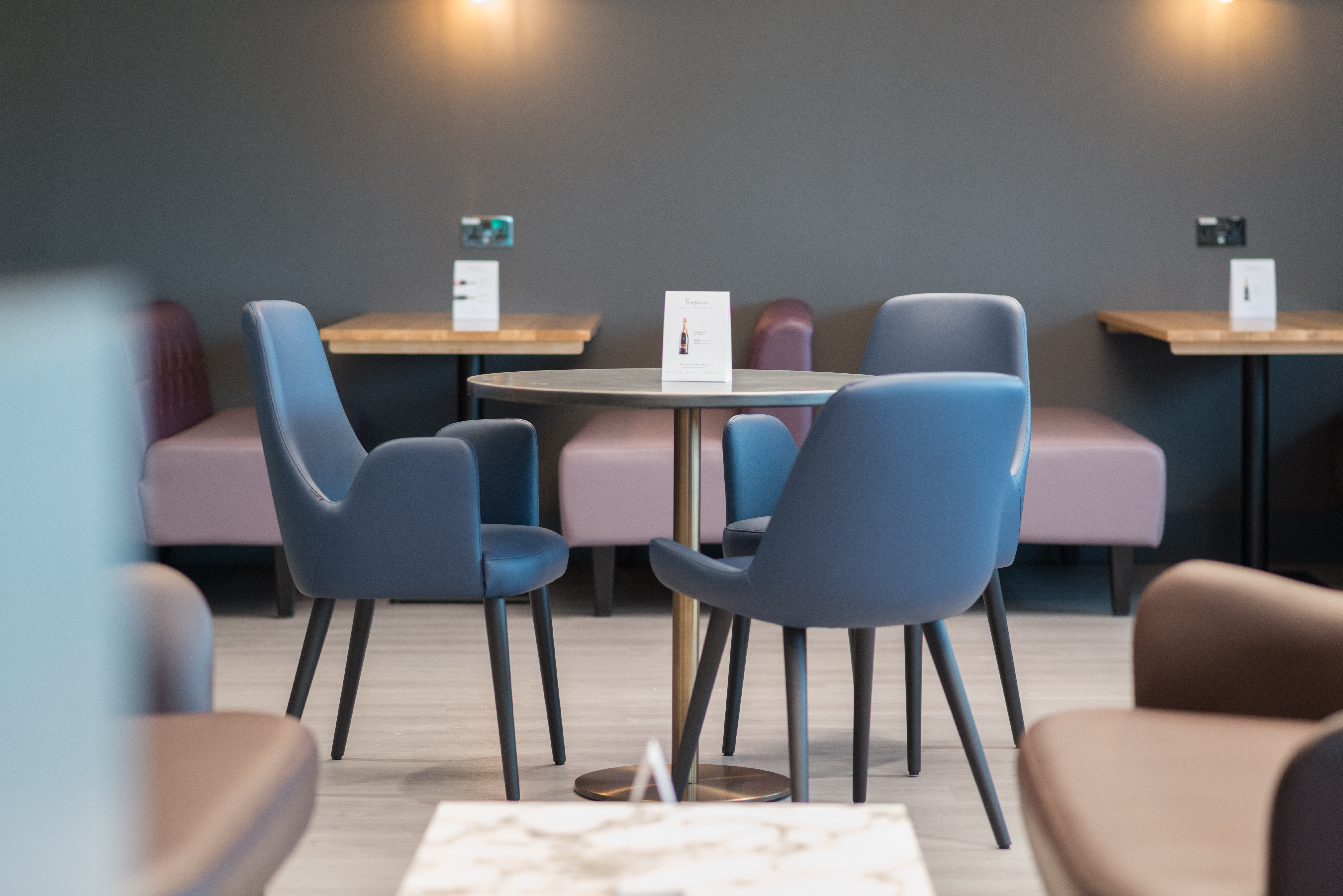 Circle table with three comfortable chairs at Birmingham South Aspire Lounge.