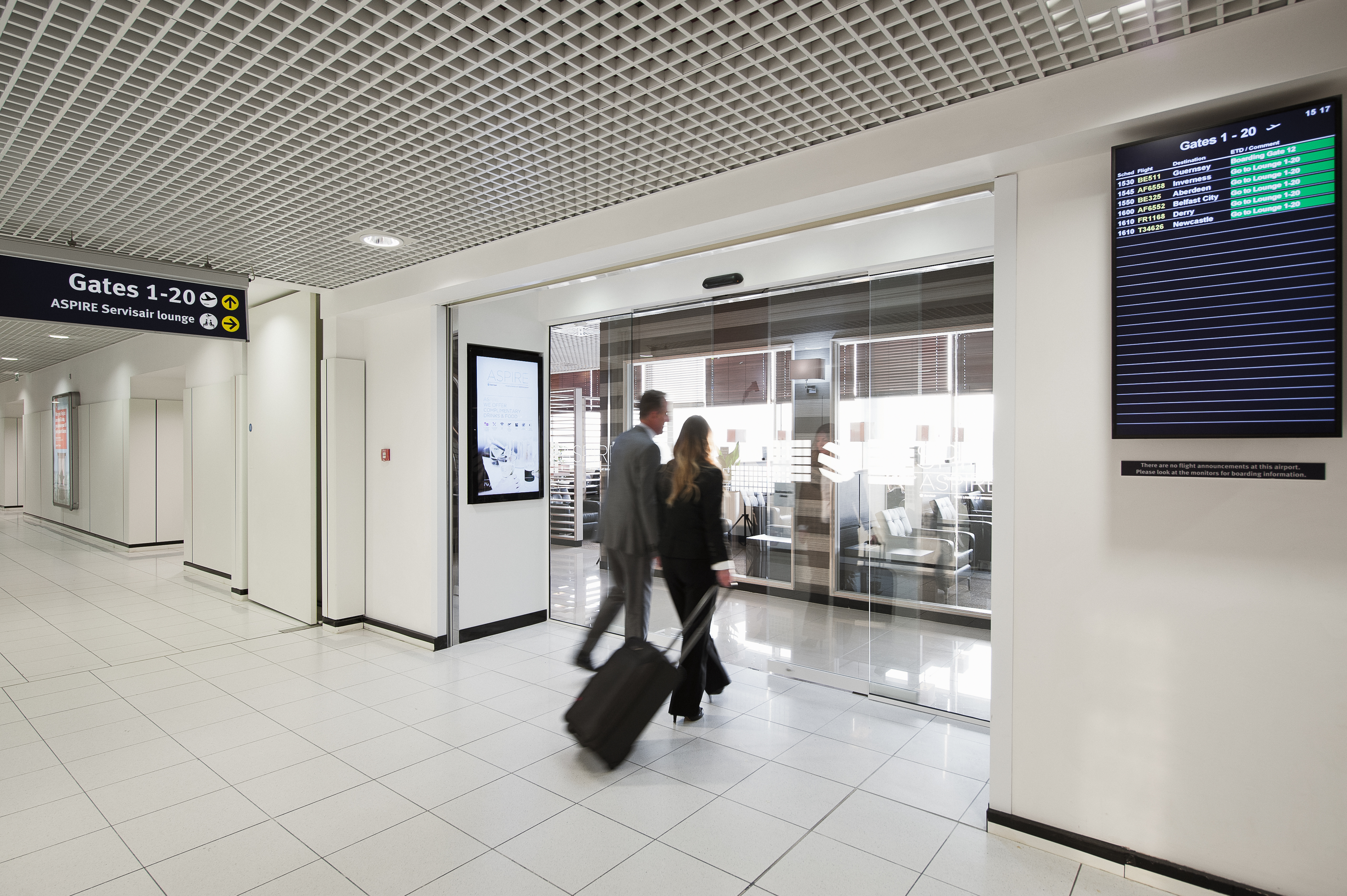 Two guests arriving at the Birmingham Aspire Lounge.