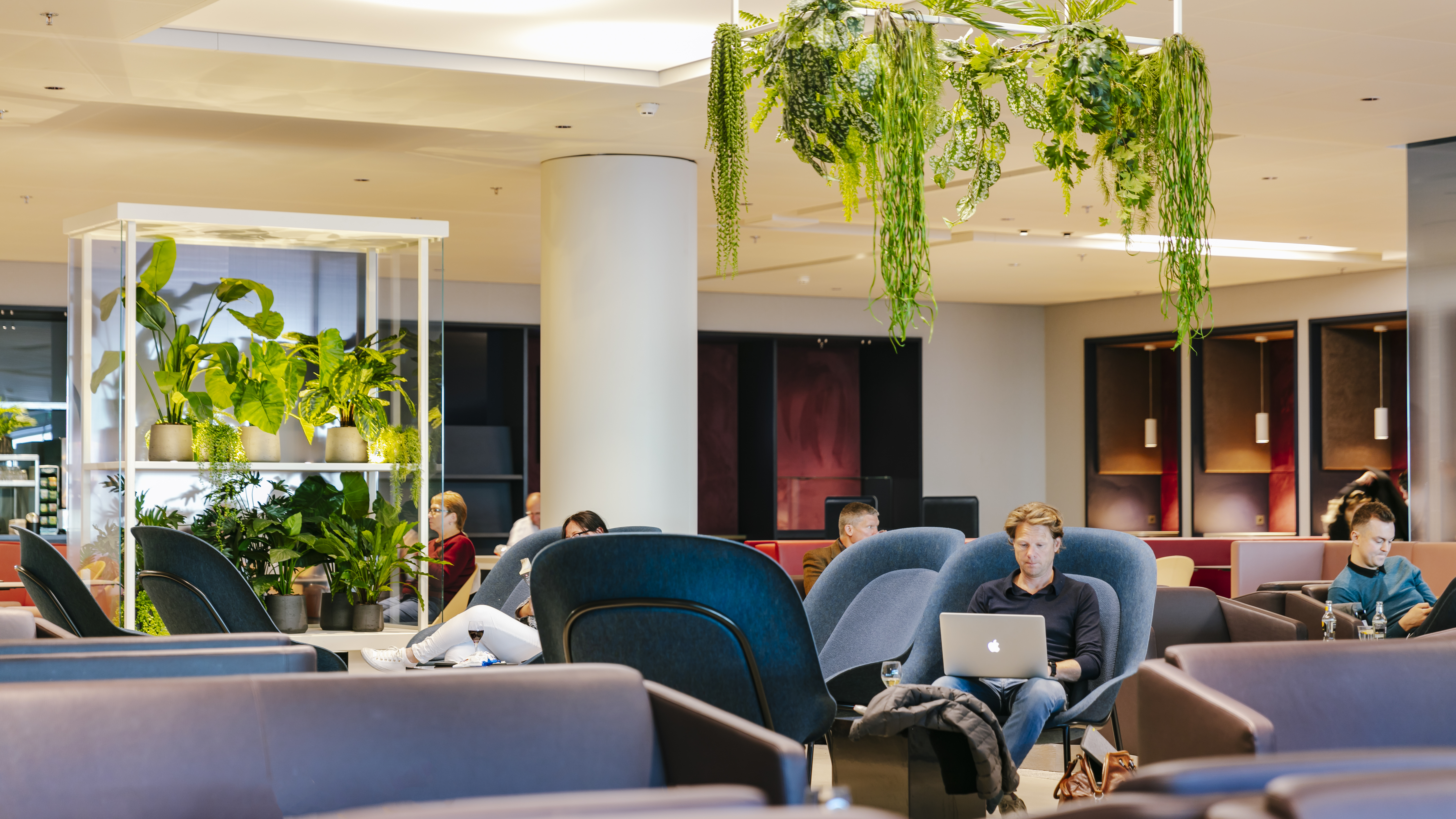 Comfortable seating in a bright, vibrant seating area at Amsterdam Gate 27 Aspire Lounge.
